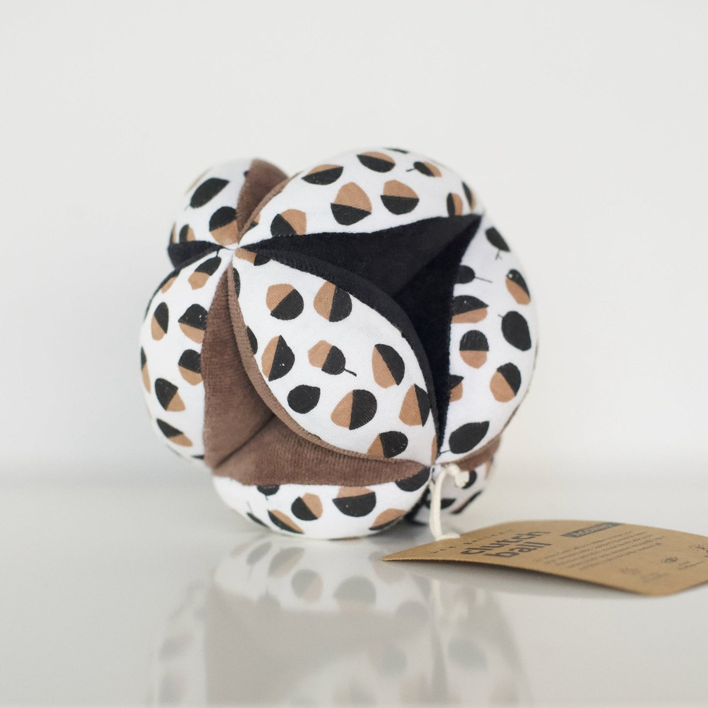 Neck pillow with patterned cover on a white surface