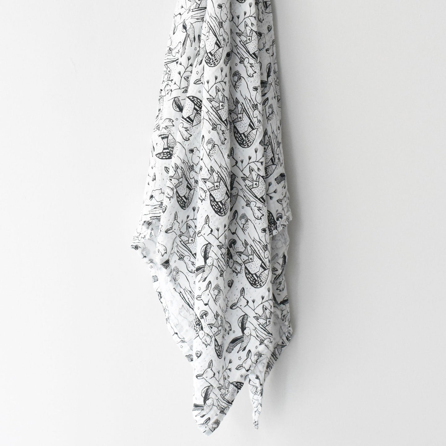 White fabric with black nautical pattern hanging on a white wall