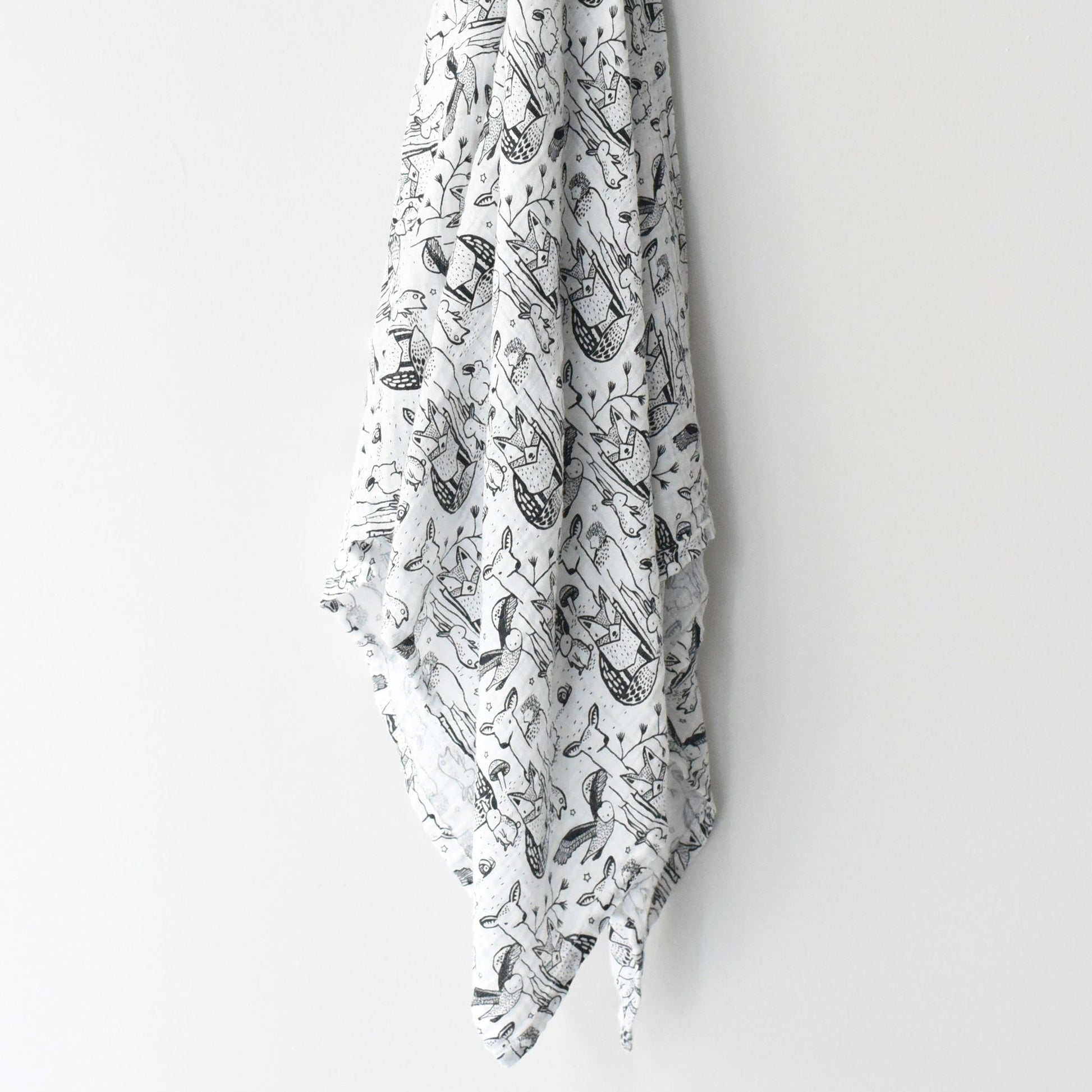 White fabric with black nautical pattern hanging on a white wall