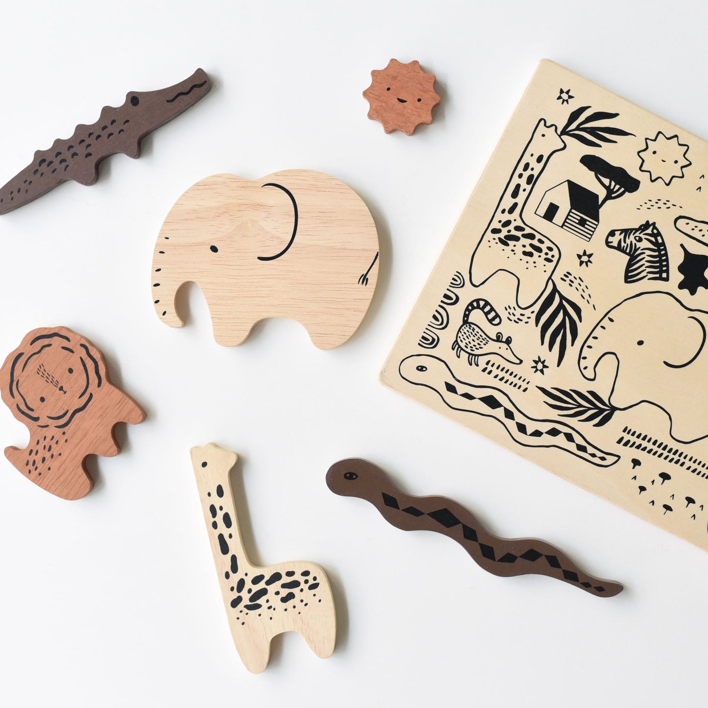 Wooden animal toys and stamp pad on a white background