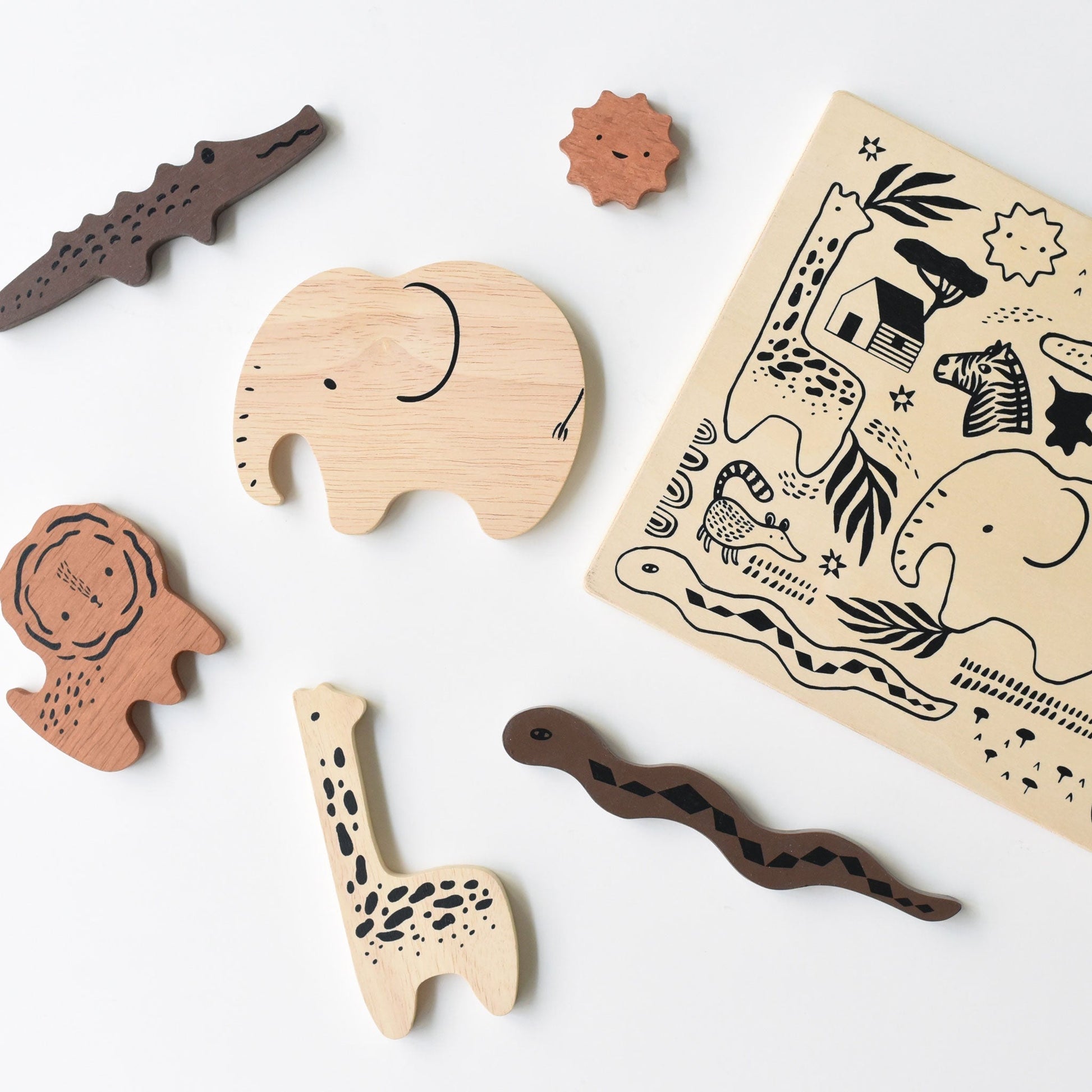 Wooden animal toys and stamp pad on a white background