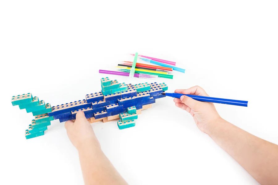 Kid coloring a shark built from the Ocean Bamboo Eco-Bricks™ set